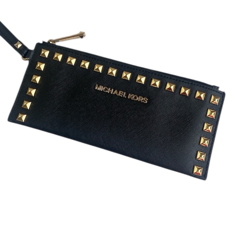 Michael Kors zip top wristlet wallet in black leather with gold tone studs.